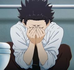 an anime character sitting on the floor with his hands covering his face while looking at something