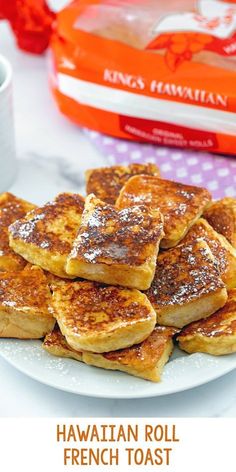 french toast on a white plate next to a cup of coffee and a red box