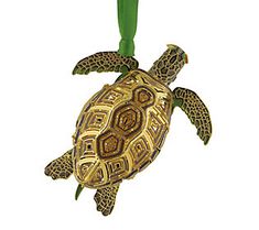 a turtle ornament hanging from a green cord