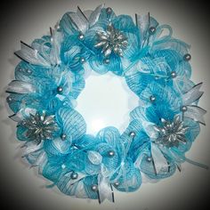 a blue wreath with silver and white decorations