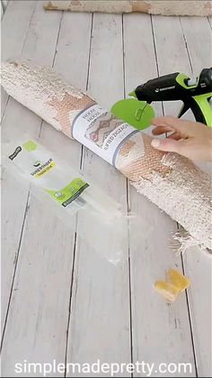 a person is using glue to attach the top of a piece of wood with scissors