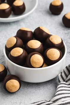 a bowl filled with chocolate covered cookies on top of a table