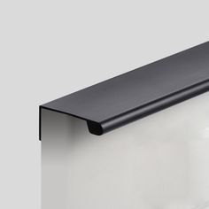 a close up of a black and white shelf on a gray wall with the bottom section missing