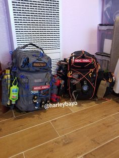 several backpacks are sitting on the floor next to each other