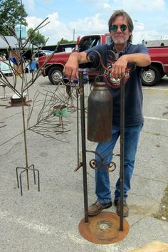 a man standing next to an old fashioned fire hydrant