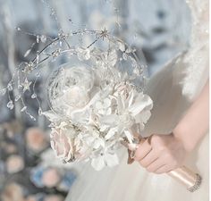 a bride holding a bouquet of white flowers