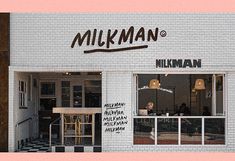 the front of a milkman coffee shop with people sitting at tables in the window