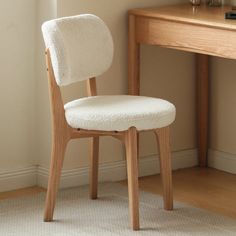 a white chair sitting next to a wooden desk