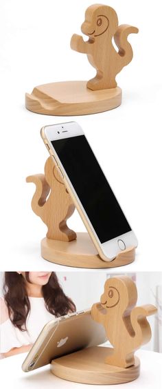 the phone holder is made out of wood and has an elephant on it's back