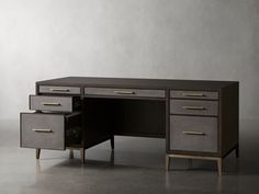 an office desk with two drawers on each side and one drawer at the top, in front of a gray wall