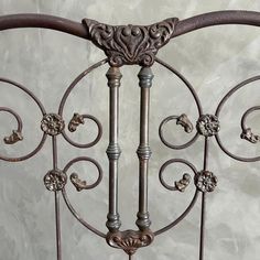 an ornate iron bed frame with decorative designs