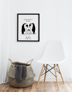 two penguins kissing each other in front of a white wall with a black and white frame