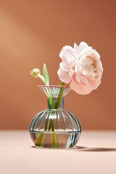 there is a glass vase with flowers in it