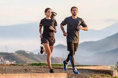 two people are running up some steps