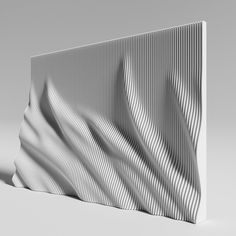 a white sculpture with wavy lines on it