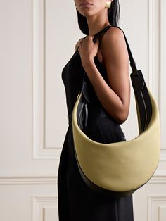 KHAITE's bag is an enduringly chic style you'll carry for years to come. Made from durable canvas, it has leather trims stamped with the brand's logo and a comfortable shoulder strap. Inside you'll find plenty of space for your wallet, phone and keys plus a tablet, water bottle and sunglasses. Ferragamo Bag, Denim Flats, Flat Dress Shoes, Dress Flats, Boot Pumps, Personal Project, Canvas Shoulder Bag, Bag Dress, Ski Wear