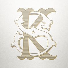 the letter k is made up of letters and numbers in gold foil on white paper