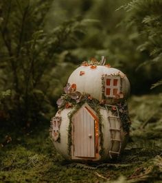 a small house made out of a pumpkin in the woods