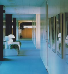 an empty hallway with planters on either side