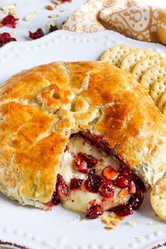 a white plate topped with a pie and crackers