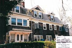 a large black house with lots of windows and shutters on the second story is shown