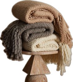 a pile of blankets sitting on top of a wooden table