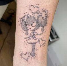 a small tattoo on the arm of a girl with an animal and heart shaped balloons