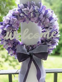 a purple and white wreath with the word welcome on it