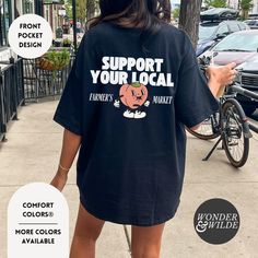 "Support Your Local Farmer's Market" Retro Adult Comfort Colors Shirt -Back and front pocket design :: GARMENT INFO :: - 100% ring-spun cotton - Medium fabric (6.1 oz/yd² (206.8 g/m - Pre-shrunk cotton for size retention and a signature sewn-in twill label - Made using 100% US cotton that is ethically grown and harvested - Soft-washed, garment-dyed fabric - The sleeves are rolled up for display purposes only :: SIZING :: - Unisex sizes - Please check out our size chart for measurements to ensure an accurate fit - For the popular oversized look, please size up 1-2 sizes - No exchanges/returns for wrong size orders :: WASHING INSTRUCTIONS :: - Cold (max 30C or 90F) - Do not bleach - Tumble dry: low heat - Iron, steam or dry: low heat - Do not dry clean :: PRODUCTION & SHIPPING :: - All items Front Pocket Design, Farmer Girl, Ghost Tee, Peach Shirt, Bookclub Gifts, Ghost Shirt, Comfort Colors Shirt, Book Shirts, Funny Graphic Tees