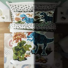 four pillows with dinosaur designs on them