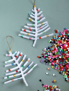 a christmas tree ornament made out of plastic beads on a cell phone screen