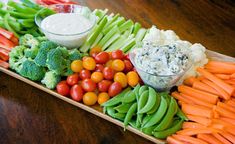 a platter filled with vegetables and dip