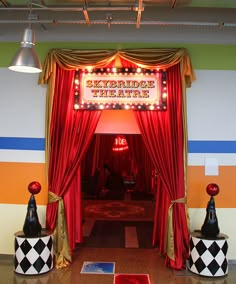 the entrance to an entertainment theatre with red curtains