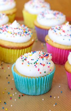 Close-up of colorful cupcakes topped with fluffy buttercream frosting and rainbow sprinkles on a baking mat, showcasing the perfect texture of homemade frosting. Light And Fluffy Frosting, Birthday Cake Frosting, Frosting From Scratch, Basic Buttercream Recipe, Best Chocolate Buttercream Frosting, Fluffy Buttercream Frosting, Fluffy Buttercream, Easy Buttercream Frosting, Boxed Cake Mixes Recipes