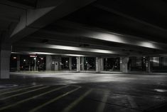 an empty parking garage at night with no one in the car or onlookers