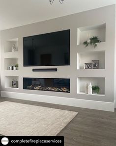 a large flat screen tv mounted on the wall above a fireplace in a living room