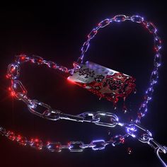 a metal chain with red and blue lights attached to it, on a black background