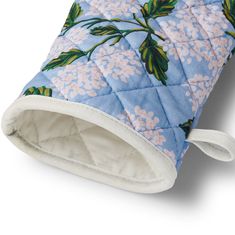 a blue and white quilted pot holder with pink flowers on the inside of it