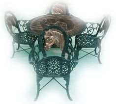 a metal table and chairs with an animal figurine on the top one side