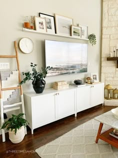 a living room filled with furniture and a flat screen tv mounted on a wall next to a fire place