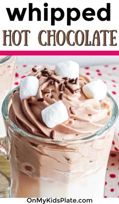 hot chocolate whip in a glass mug with marshmallows on top and the words whipped hot chocolate above it