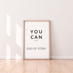 an empty wooden frame on the floor in front of a white wall that says, you can end of story