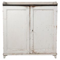 an old white cabinet with two doors