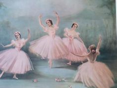 four ballerinas in pink tutu skirts are posing for a photo with their arms outstretched