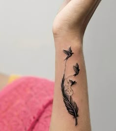 a woman's arm with a tattoo on it that has three birds flying in the air