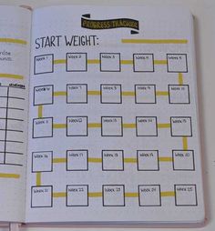 an open planner with the words start weight written in yellow and on top of it