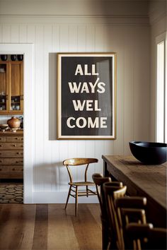 A framed black and white poster that reads "All Ways Welcome" hanging in a modern southwestern kitchen. Southwestern Entryway, Welcome Typography, Entryway Art, Boho Gallery Wall, Western Wall Art, Southwestern Decorating, Typographic Poster, Boho Eclectic, Vertical Frames