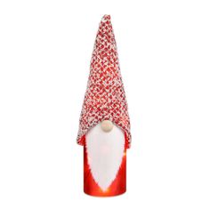 a red and white gnome hat sitting on top of a can