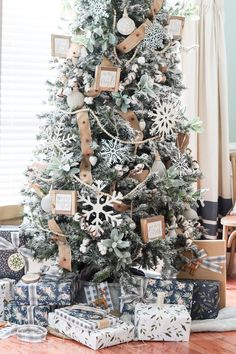 a decorated christmas tree with presents under it