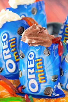 three bags of oreo ice cream sitting on top of an orange and blue table cloth